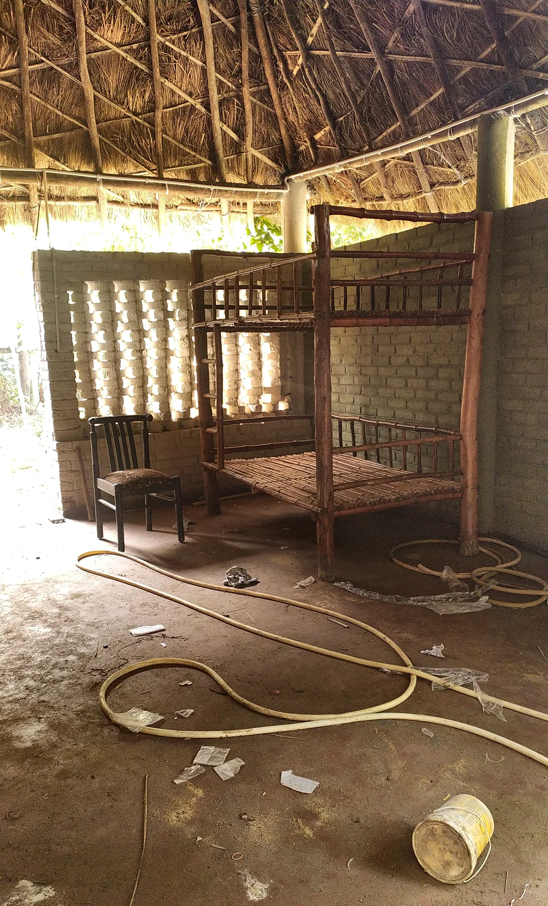 Early on: a bunk bed frame stands in the thatched room, before the finishes.