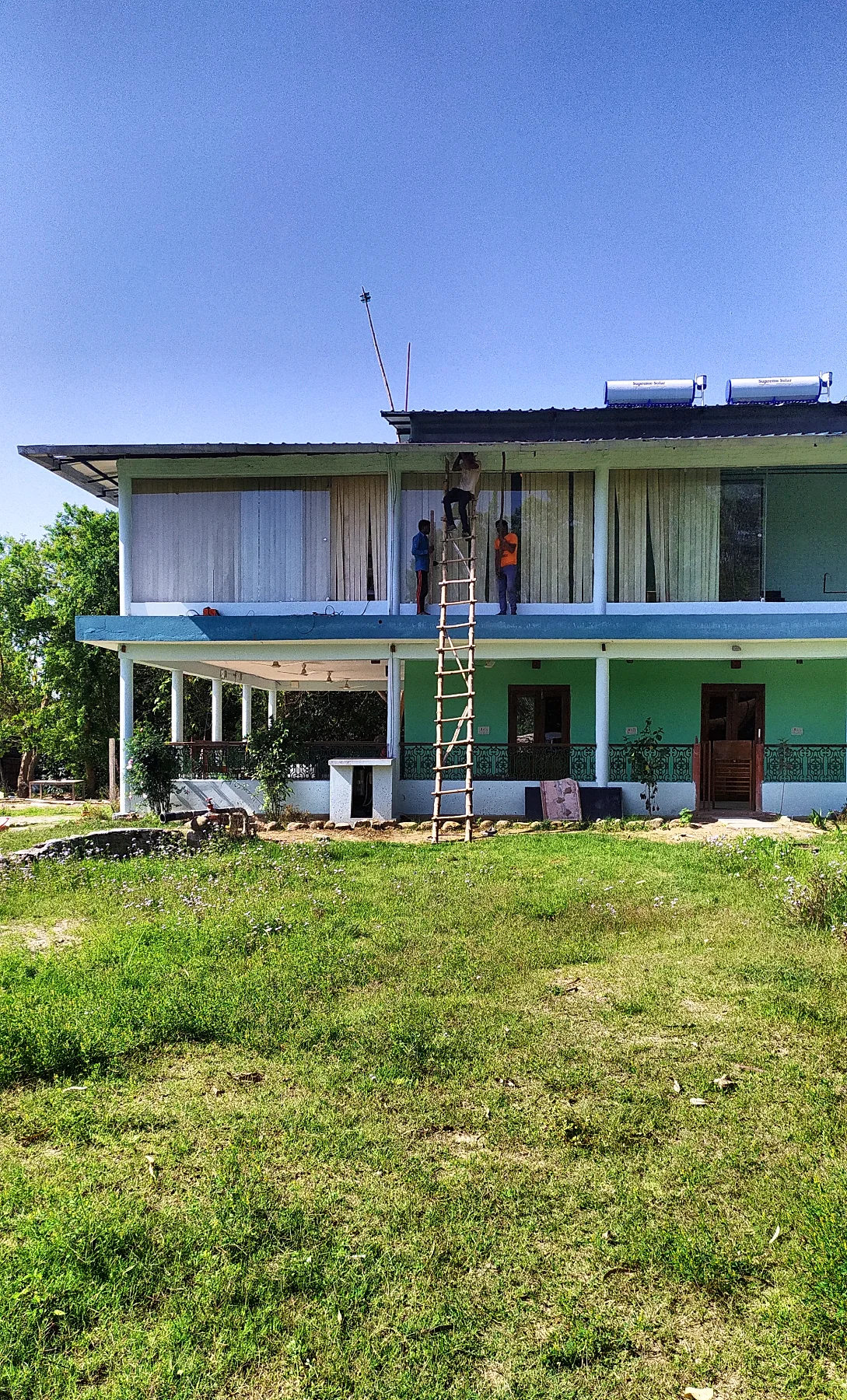 The house by day, with the bamboo ladder still against the upper floor.